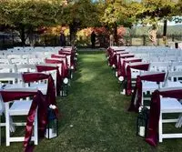 A row of chairs with red covers in the middle.