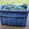 A blue bin of lights sitting on the ground.