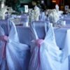 A table with many chairs and tables in the background