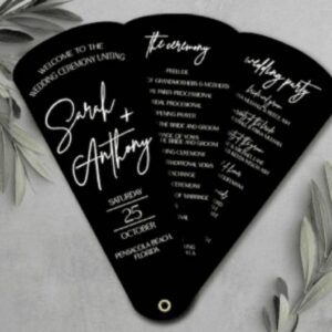 A fan shaped wedding program with white ink and black lettering.