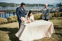 A couple getting married by the water