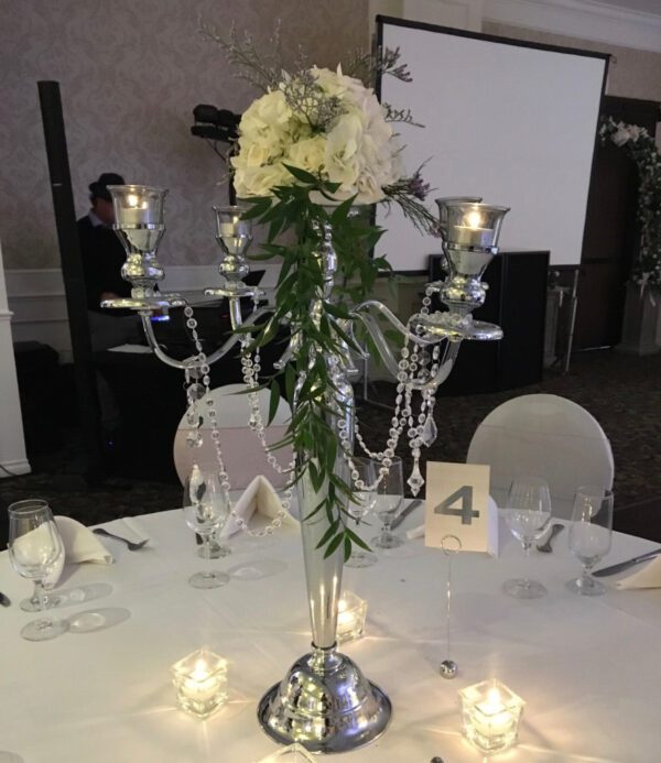 A table with candles and flowers on it