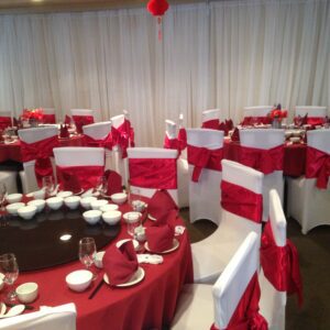 A room with red and white decor and tables