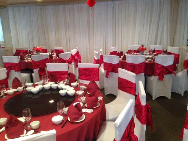 A room with red and white decor and tables