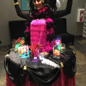 A woman in costume sitting on top of a table.