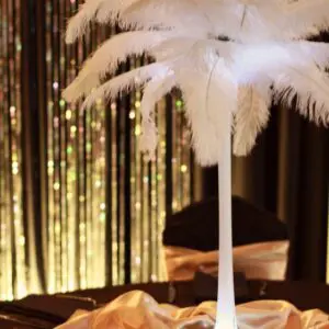 A white feather lamp on top of a table.