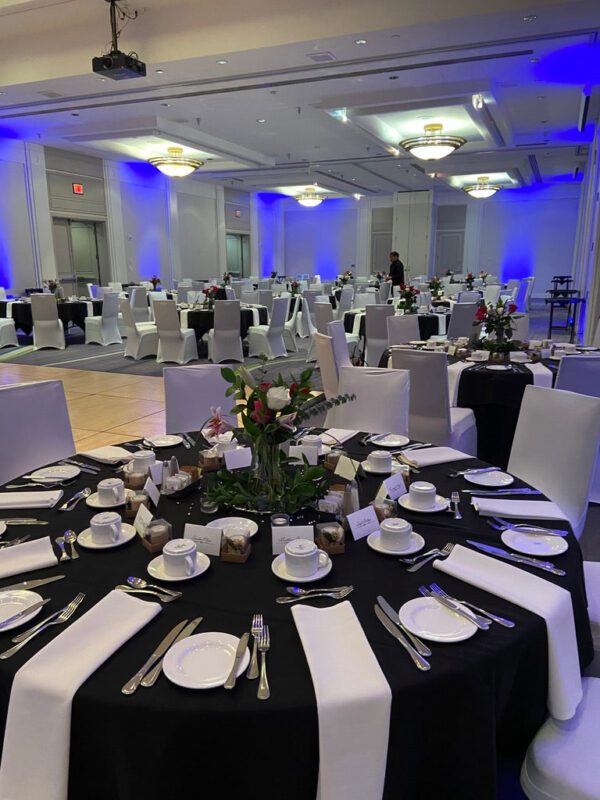 A banquet hall with tables and chairs set up for an event.