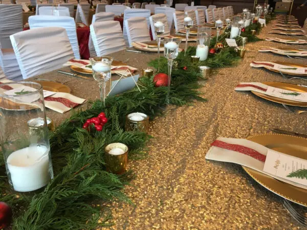 A table with candles and pine needles on it