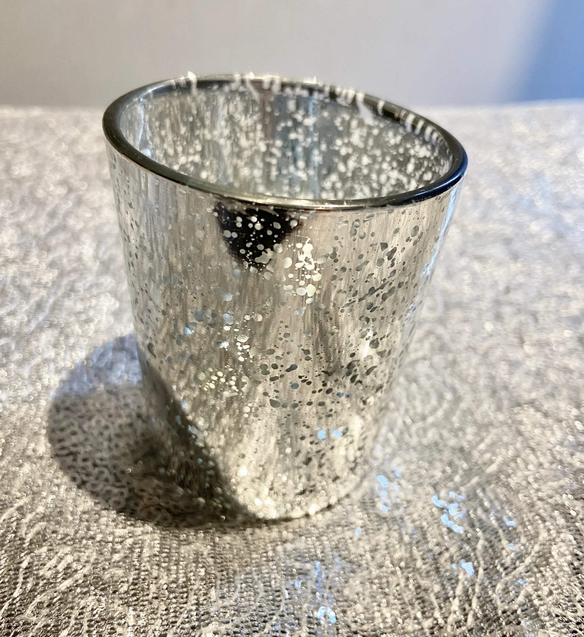 A glass cup sitting on top of a table.