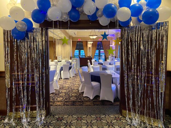 A room with many chairs and balloons on the ceiling