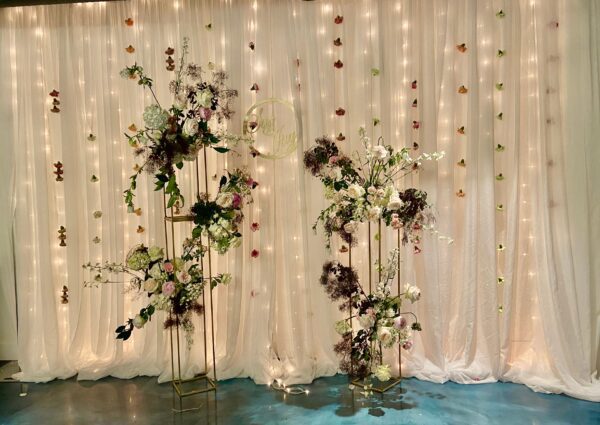 A room with flowers and lights on the wall