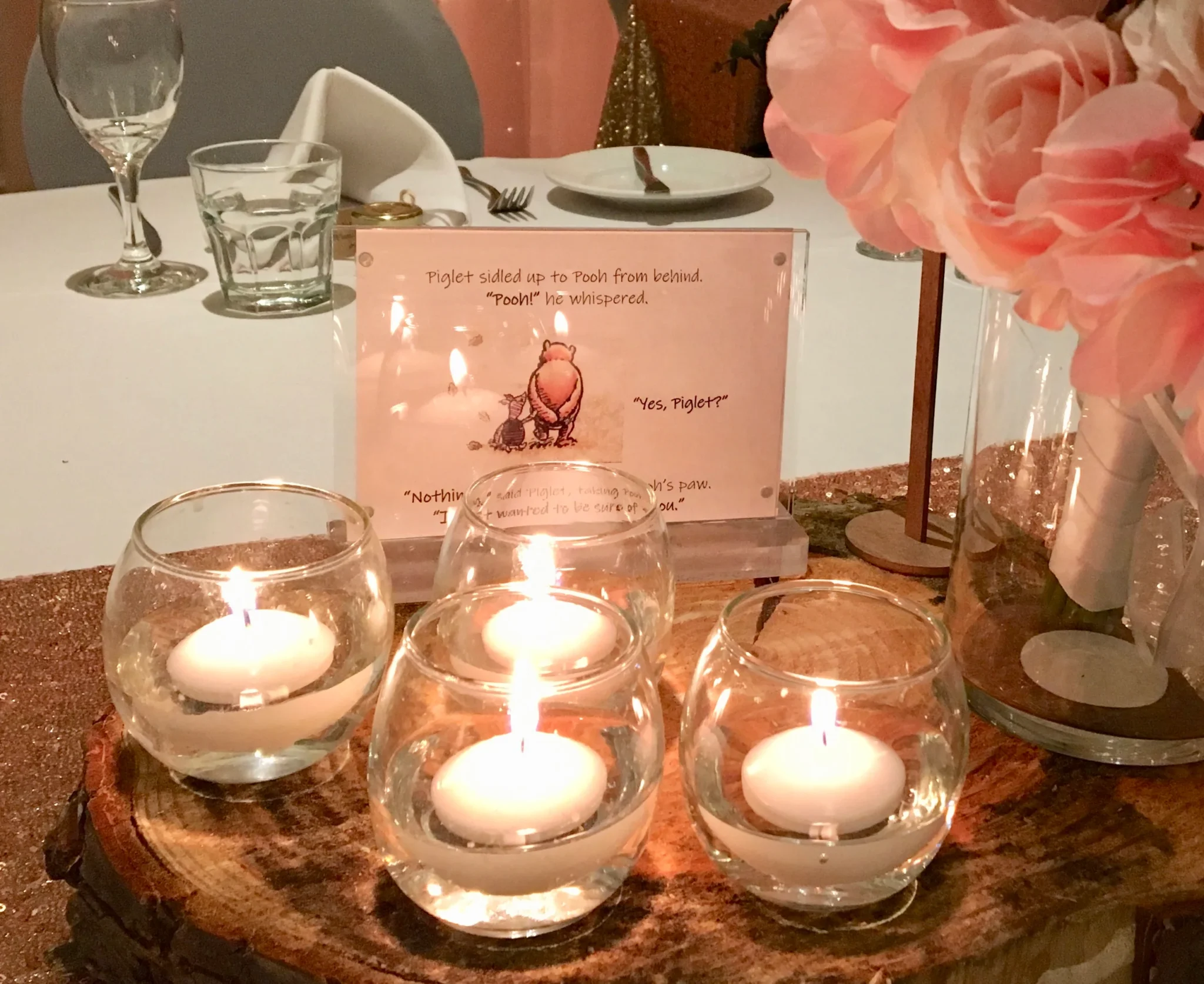 A table with three candles and a card.