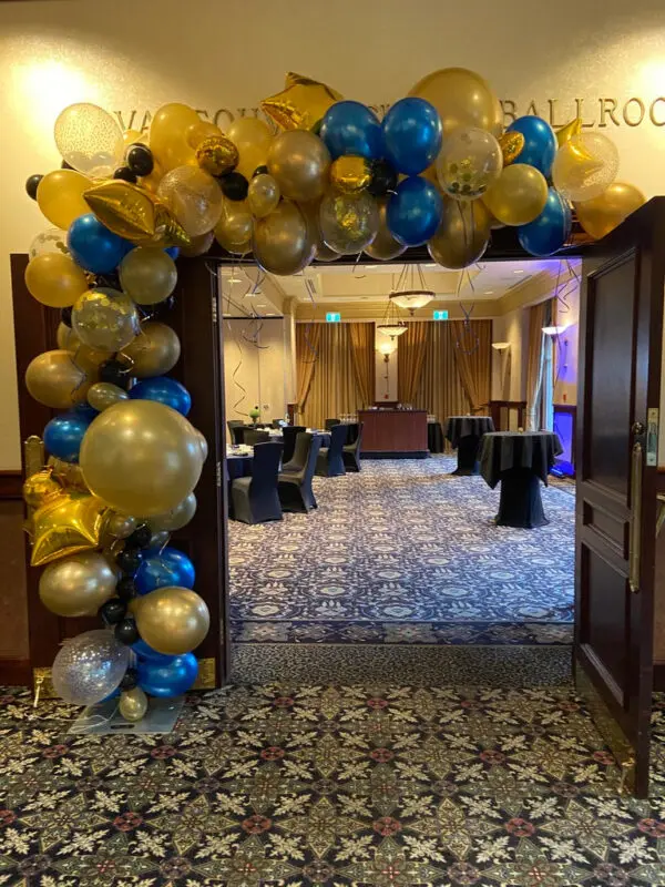 A room with balloons and tables in it