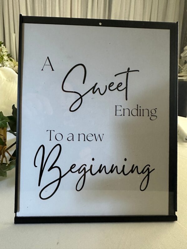 A sign that says, " a sweet ending to a new beginning ".