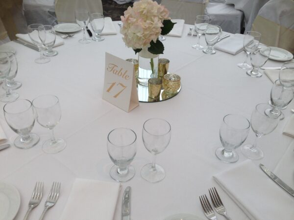 A table set with silverware and place settings.