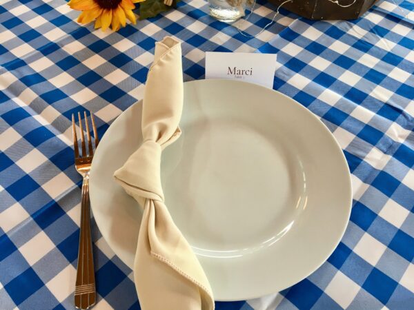 A plate with a napkin on it and silverware.