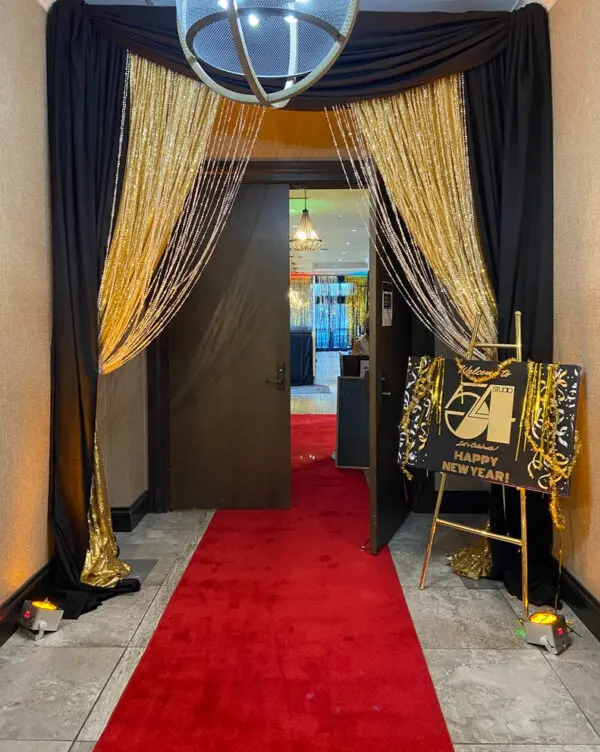 A red carpet is in the middle of an entrance way.