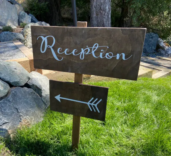 A sign that says reception with an arrow.