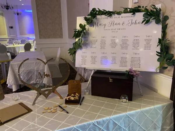 A table with a sign and many chairs