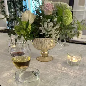 A table with flowers and candles on it