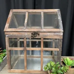 A wooden box with glass top and metal frame.