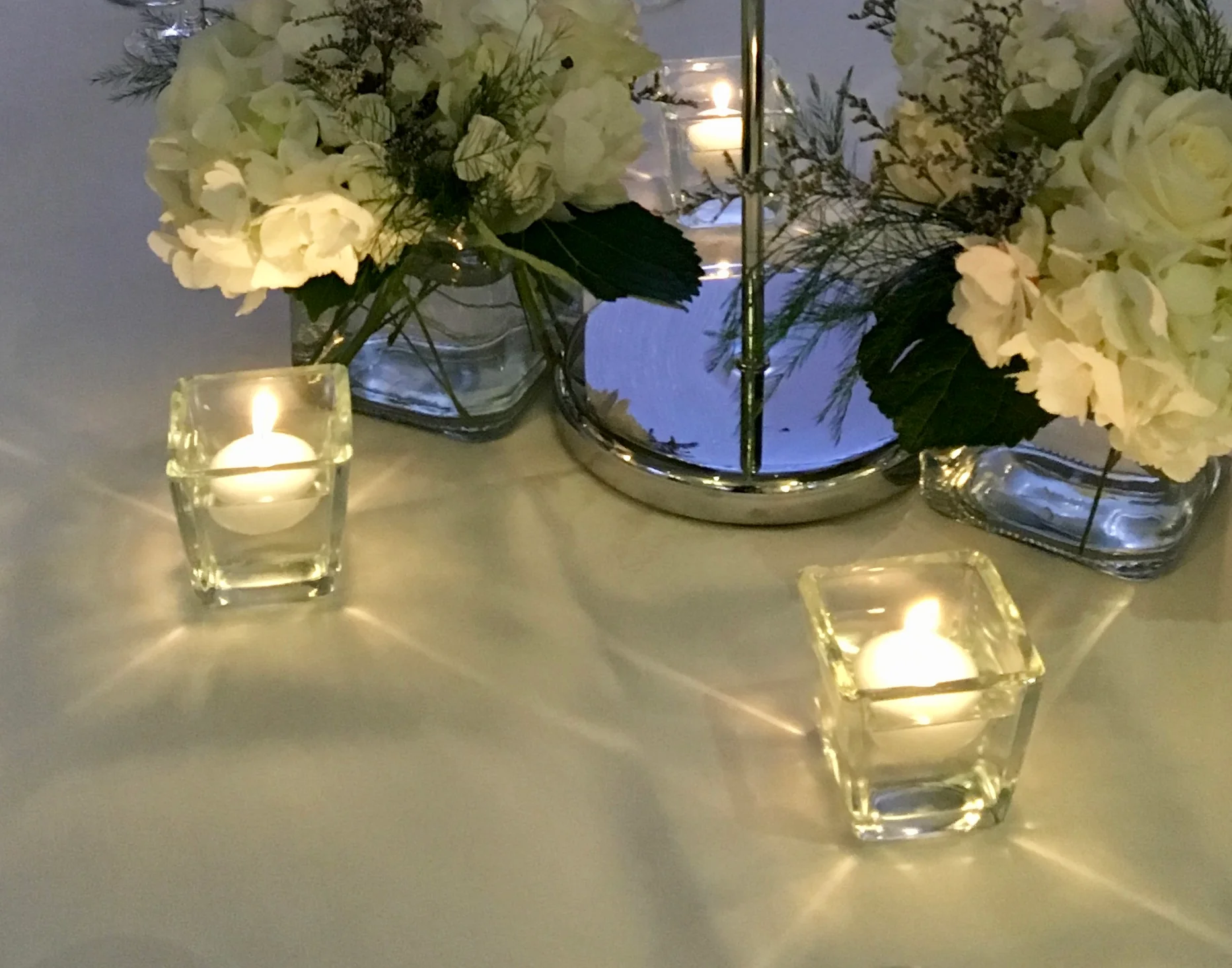 A table with candles and flowers on it