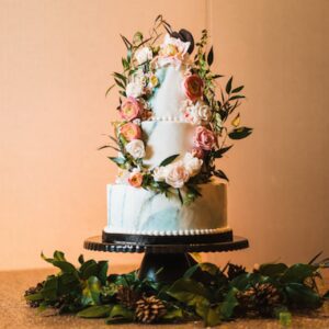 A three layer cake with flowers on top of it.