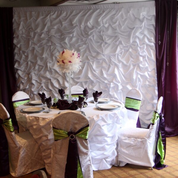 A table set up with white and green napkins.