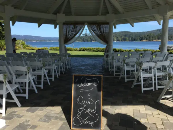 A wedding ceremony with chairs and an outdoor pavilion.