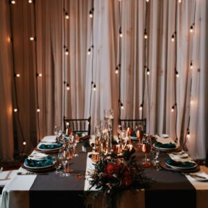 A table set with candles and plates for dinner.