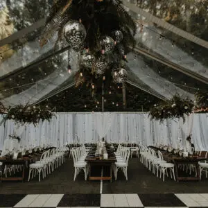 A large tent with many tables and chairs