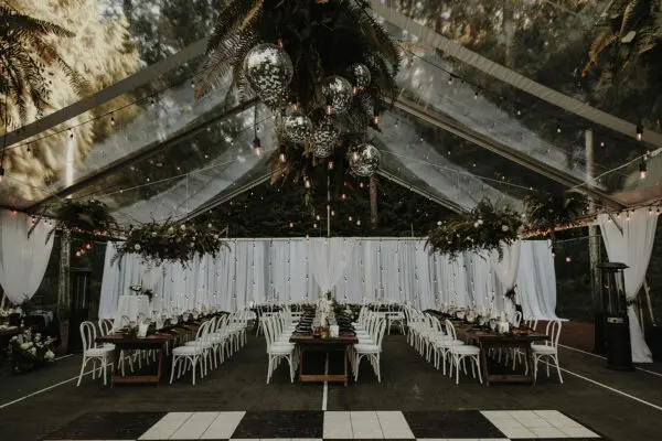 A large tent with many tables and chairs