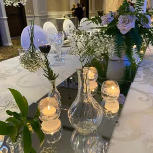 A table with flowers and candles on it