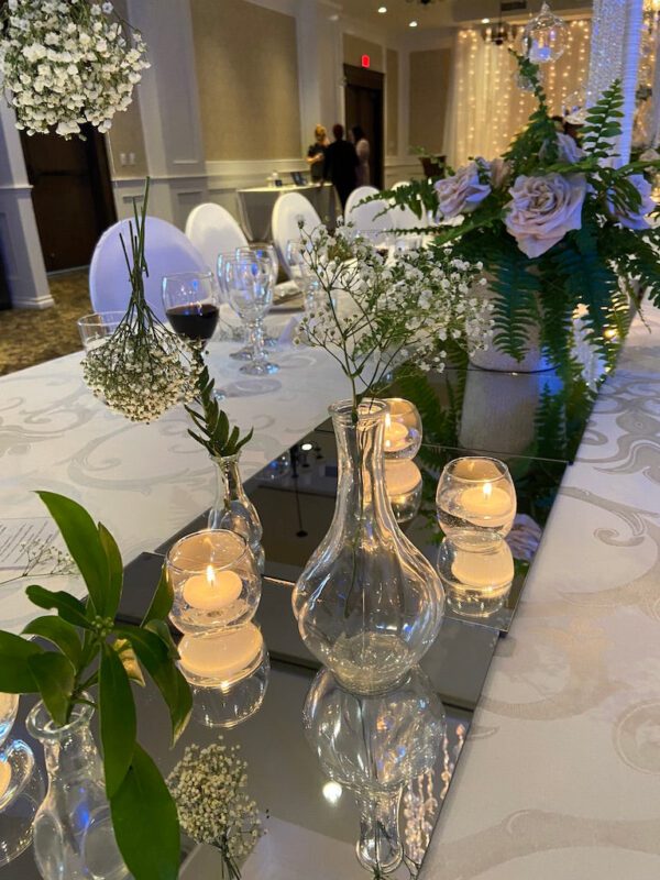 A table with flowers and candles on it