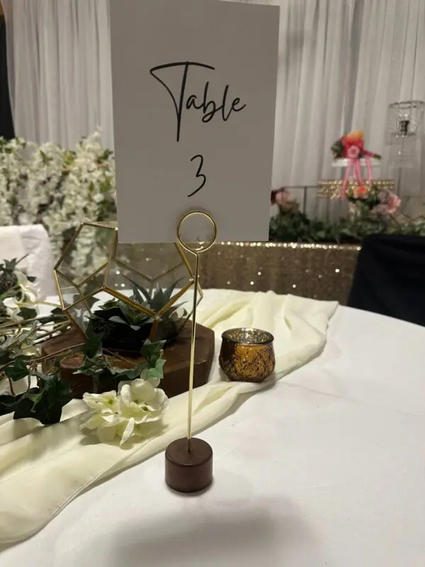 A table with a number three sign and plants