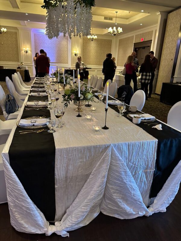 A long table with black and white napkins