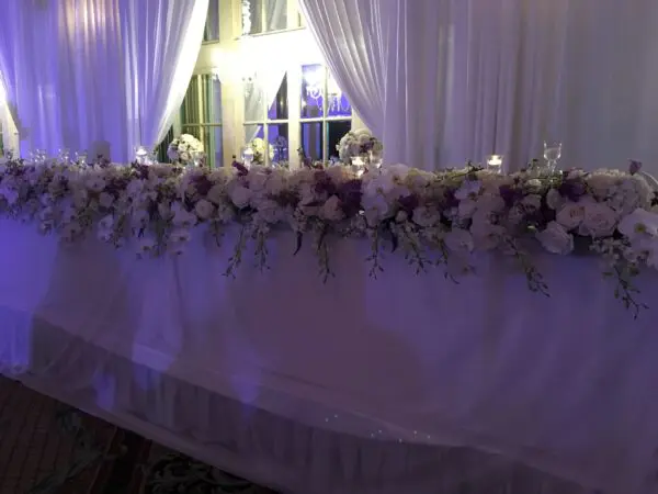 A long table with flowers and candles on it