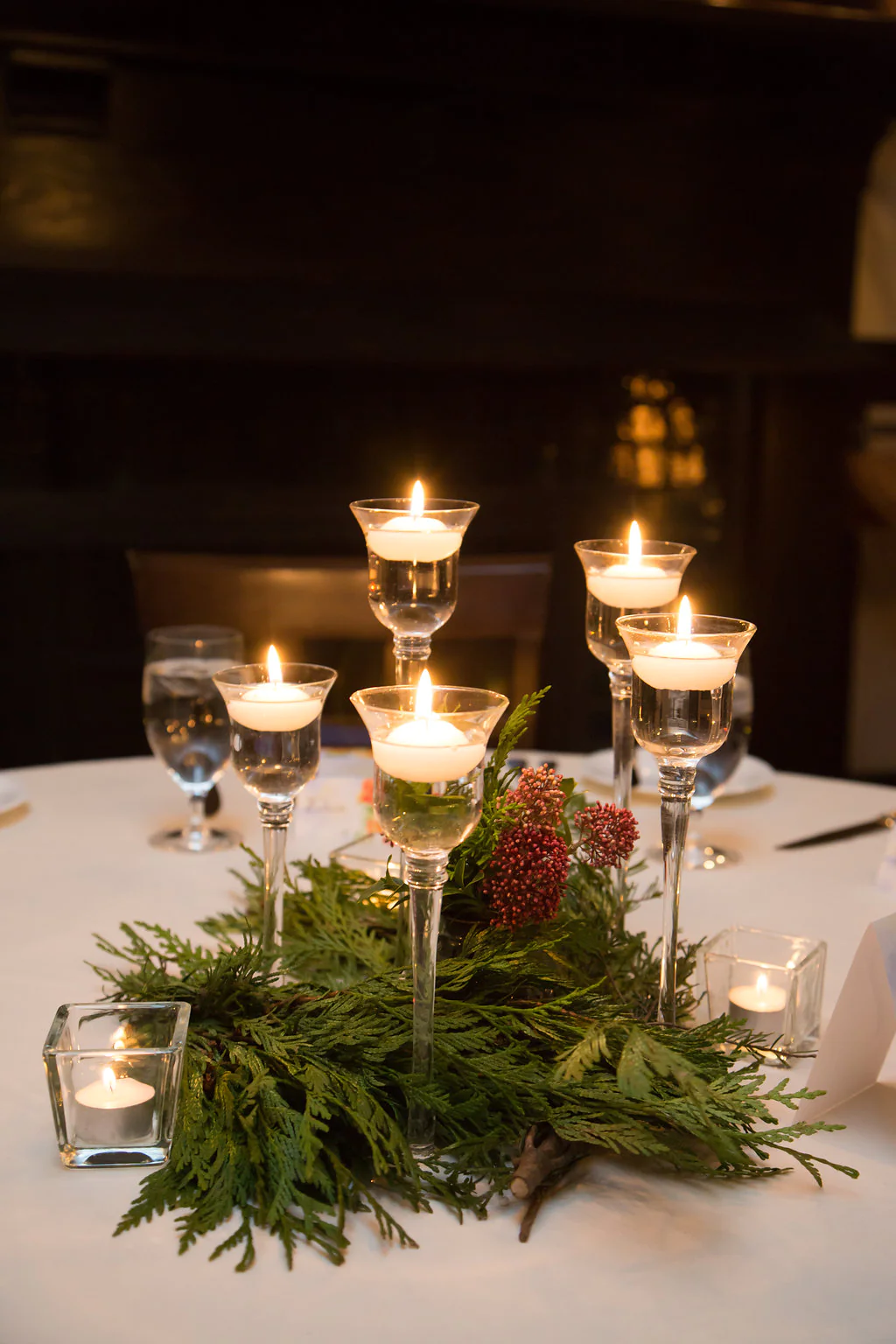 A table with candles and glasses on it