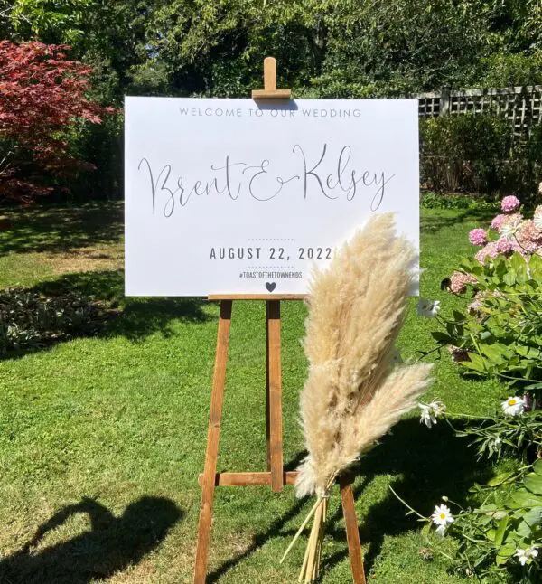 A white sign with the names of two people on it.