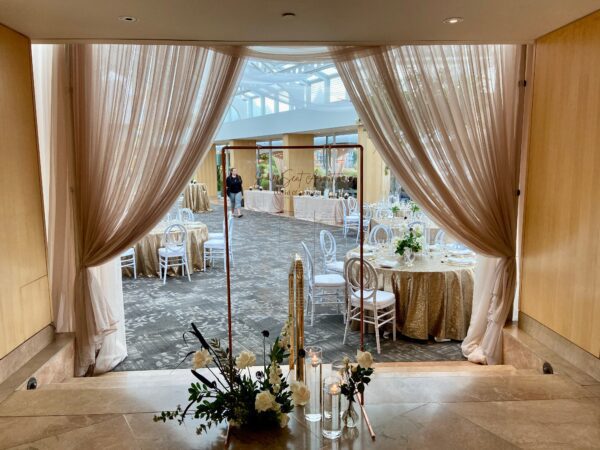 A room with a mirror and flowers on the table