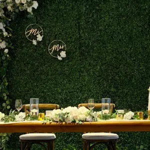 A table with two chairs and flowers on it