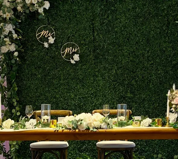 A table with two chairs and flowers on it