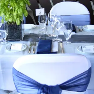 A table set with white and blue chairs.