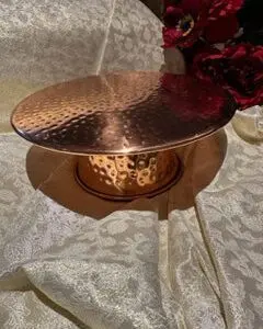 A cake plate with a metal stand on top of it.