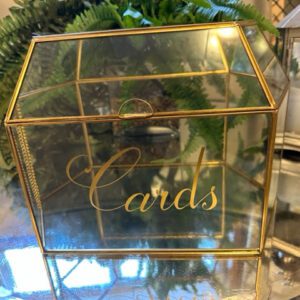 A glass box with the word cards written on it.