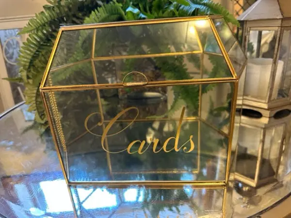 A glass box with the word cards written on it.