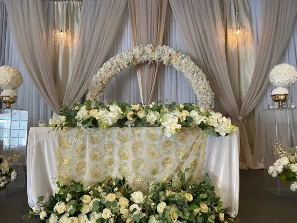 A wedding table with flowers and drapes