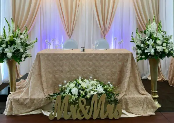 A couple of tables with flowers on top