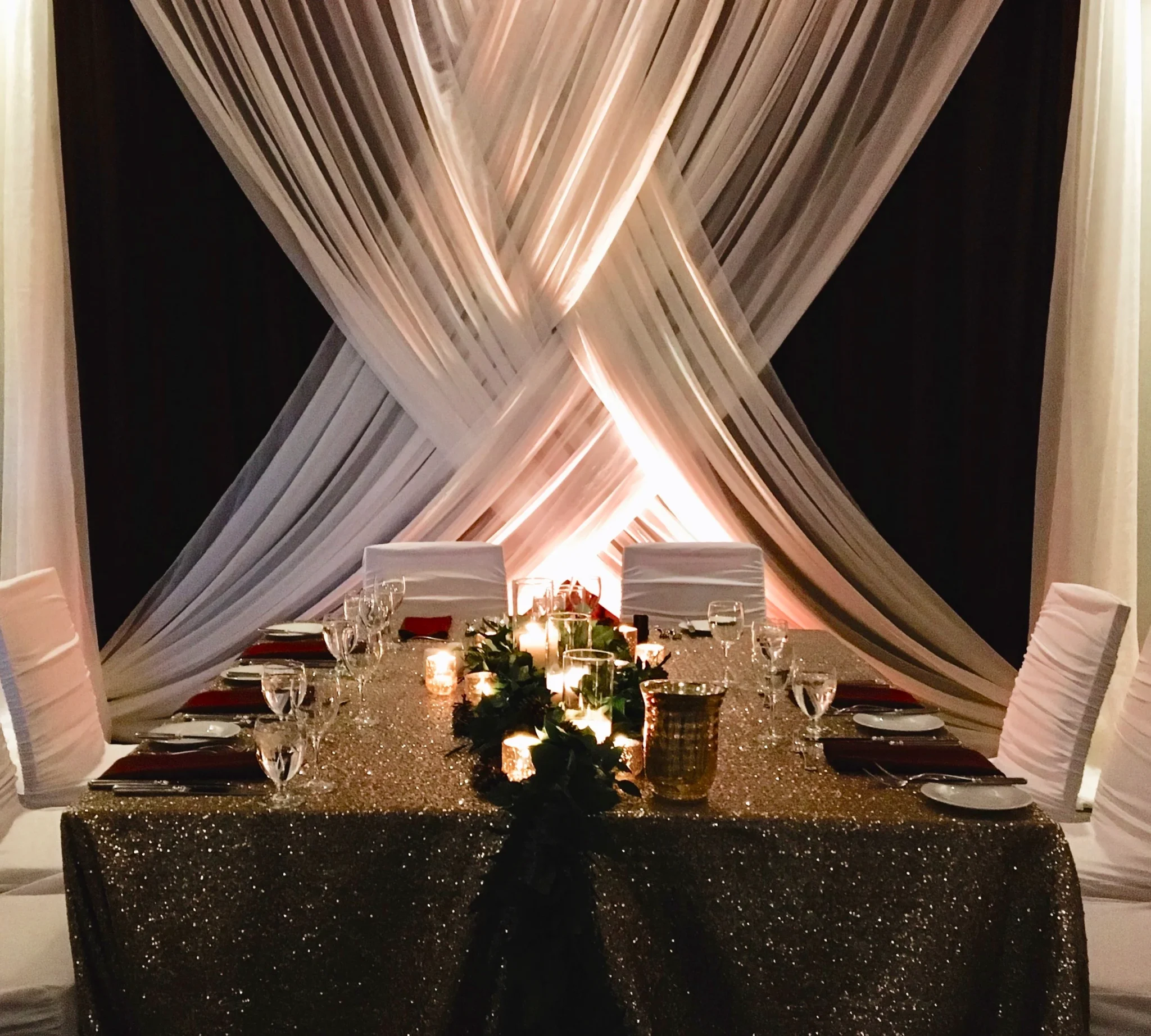 A table set up with candles and flowers.