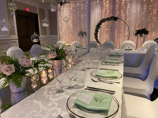 A long table with plates and silverware on it